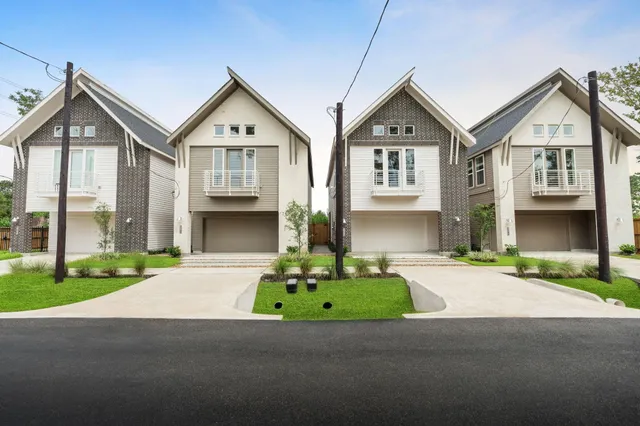 a front view of a house with a garden and yard