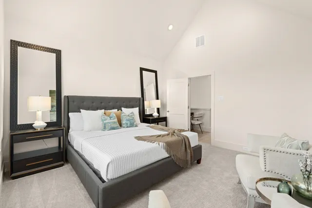 a spacious bedroom with a bed and a couch