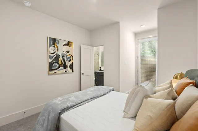 a bathroom with a sink vanity granite tub shower and a mirror