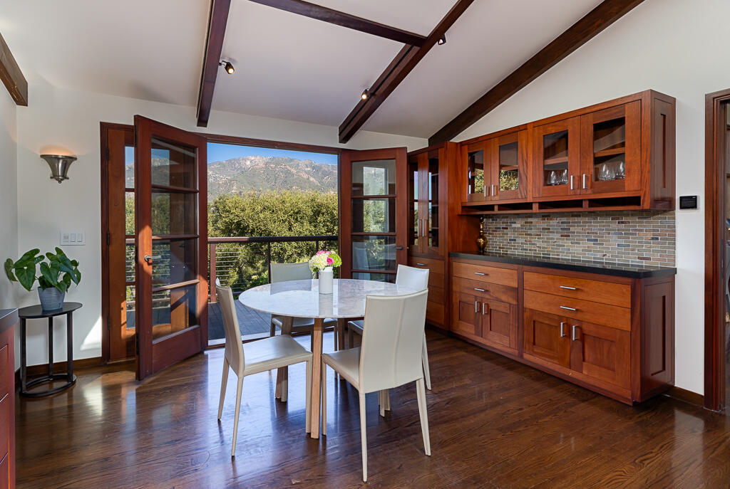 622 Cowles Road Montecito, CA 93108 - Photo 12 of 33 a kitchen with stainless steel appliances granite countertop a stove a refrigerator a dining table and chairs with wooden floor