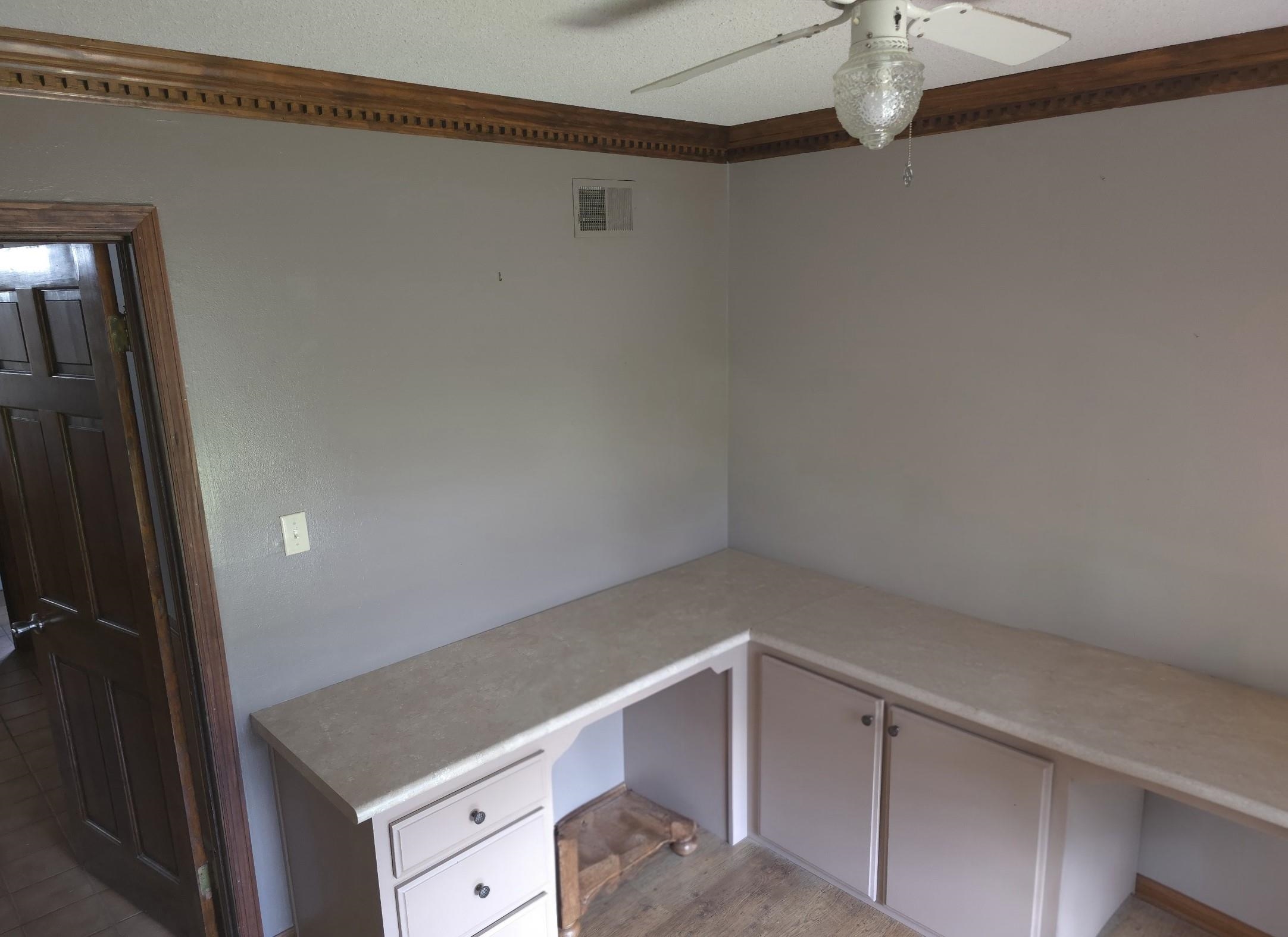 8724 Fay Road Memphis, TN 38018 - Photo 9 of 26 Unfurnished office with built in desk and ceiling fan