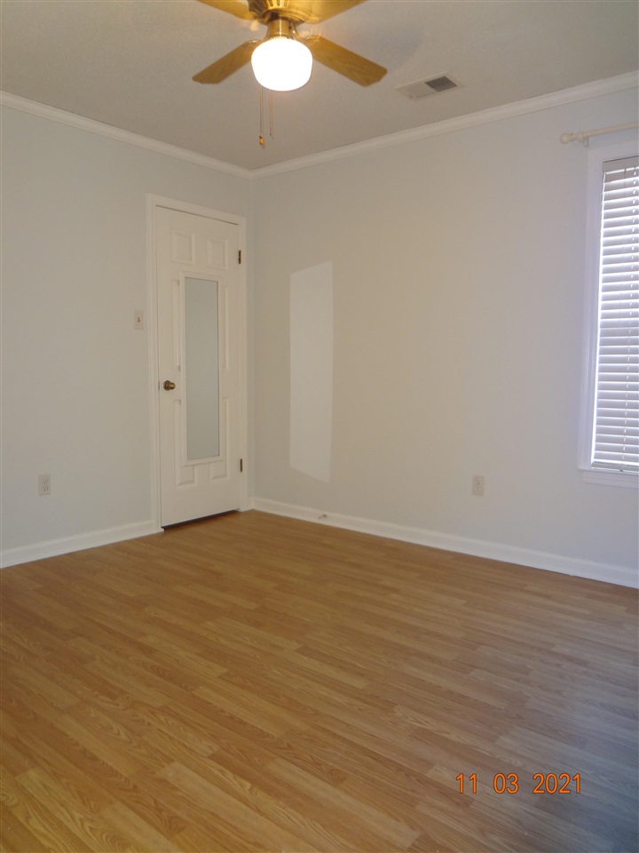 6501 Birkenhead Road Memphis, TN 38134 - Photo 14 of 17 a view of an empty room with wooden floor and a window
