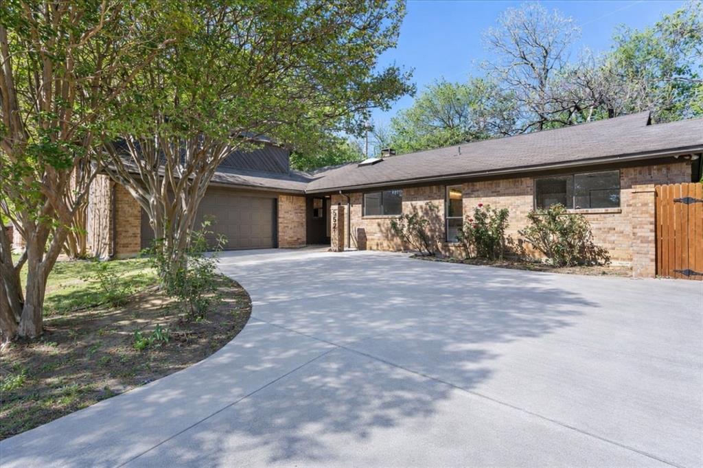 5521 Chimney Rock Road Fort Worth, TX 76112 - Photo 1 of 1 front view of a house with a garden