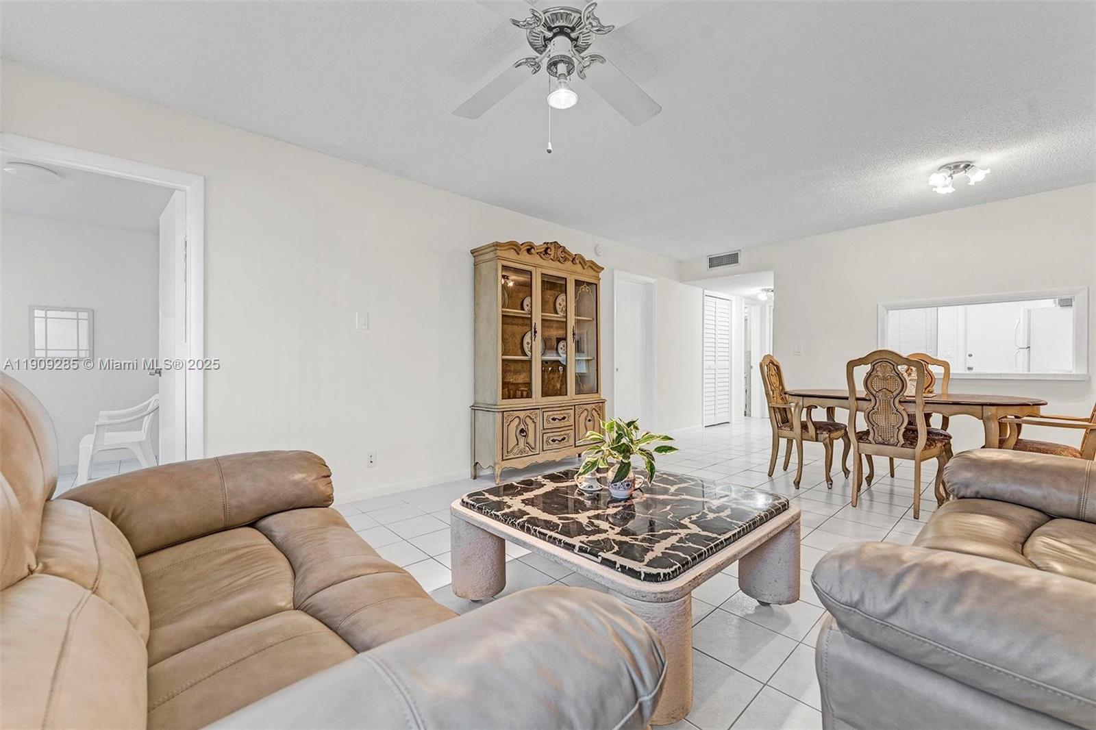 330 Southeast 2nd Street, Unit 103G Hallandale Beach, FL 33009 - Photo 19 of 37 a living room with furniture and a table