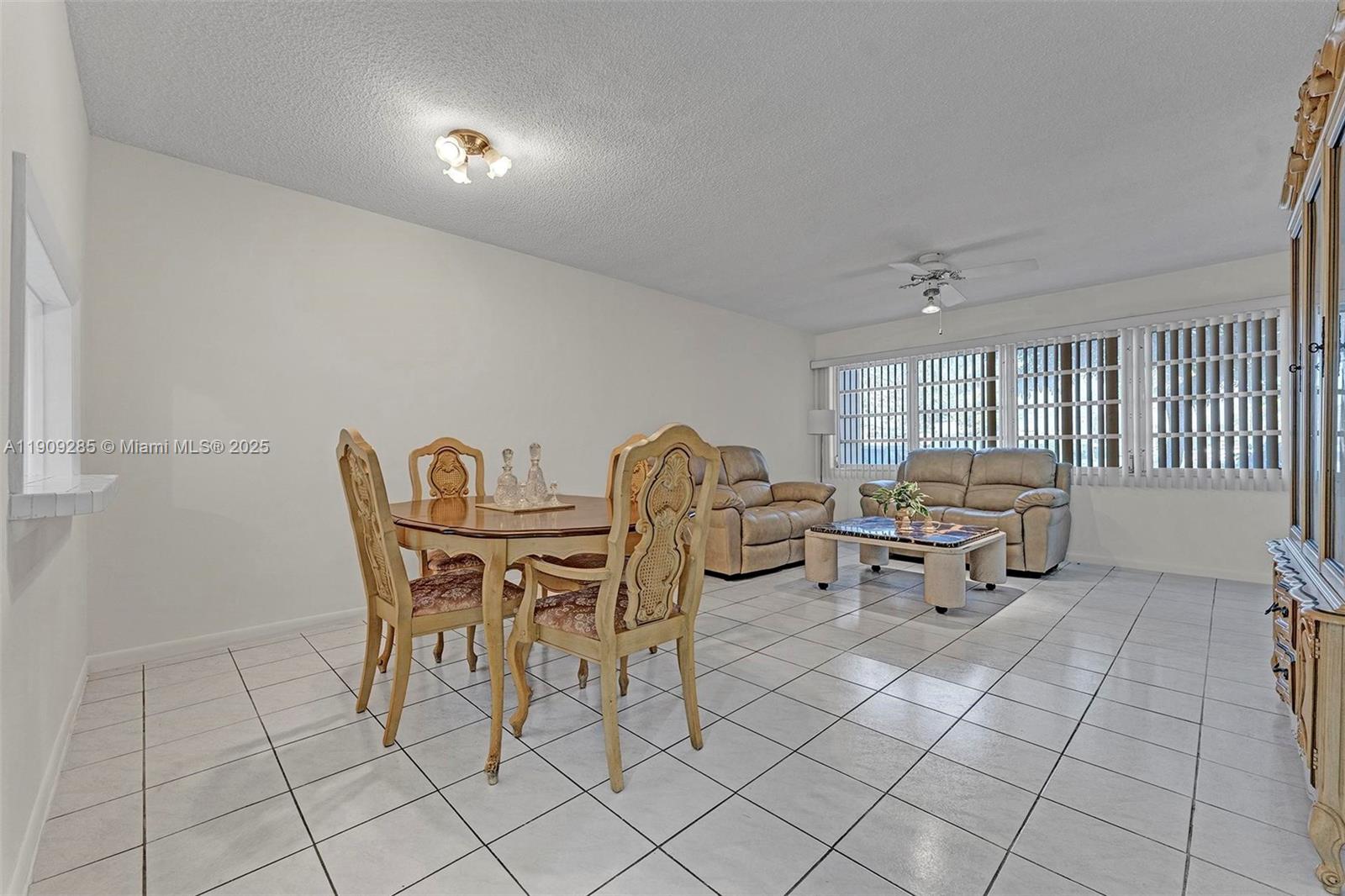 330 Southeast 2nd Street, Unit 103G Hallandale Beach, FL 33009 - Photo 20 of 37 a dining room with furniture and a chandelier