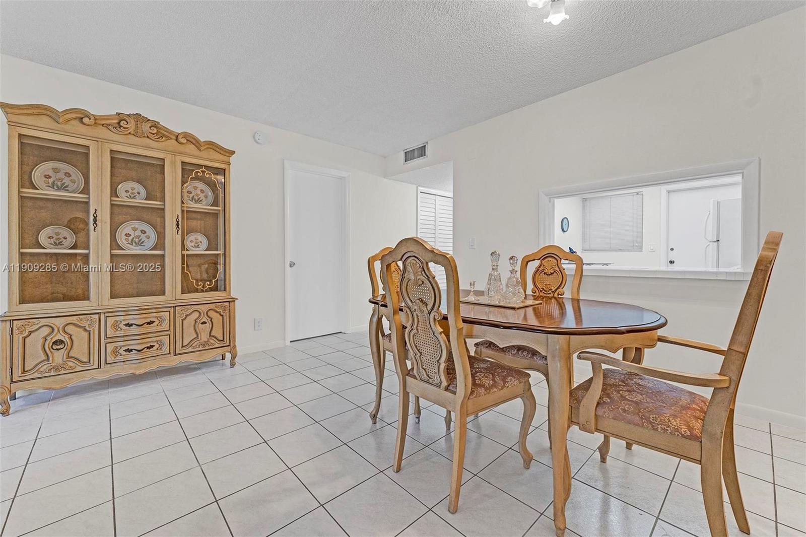 330 Southeast 2nd Street, Unit 103G Hallandale Beach, FL 33009 - Photo 21 of 37 a view of a dining room with furniture