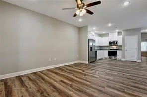 a view of a kitchen with a sink and a refrigerator
