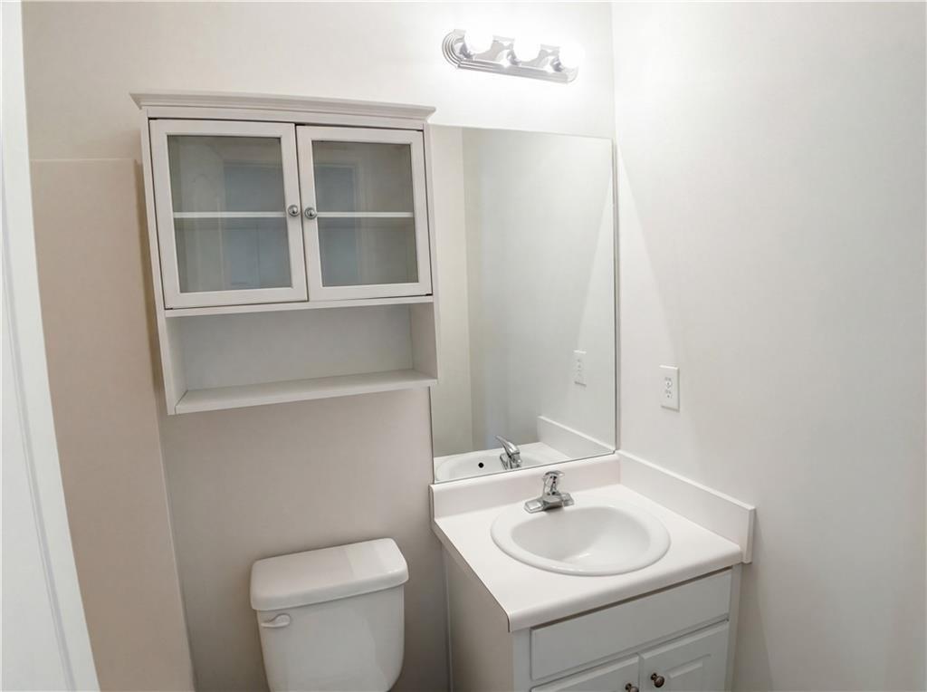 1428 Box Circle Winder, GA 30680 - Photo 11 of 19 a bathroom with a toilet sink vanity and mirror