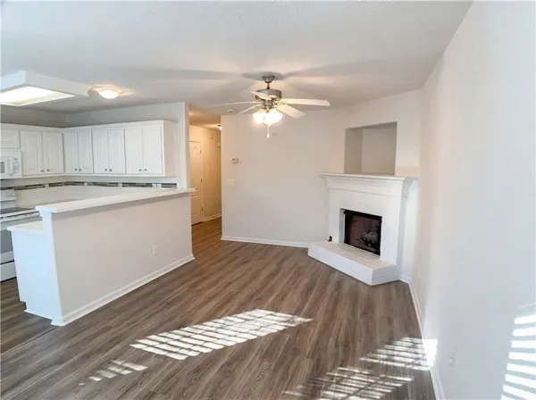 a view of kitchen with granite countertop cabinets and wooden floor