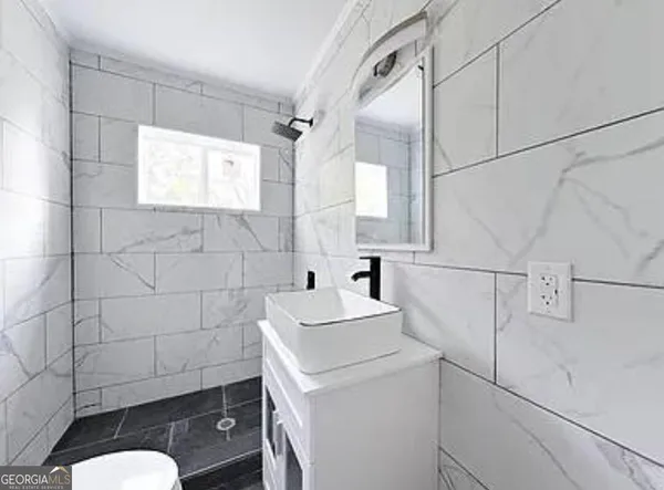 a bathroom with a sink toilet and vanity