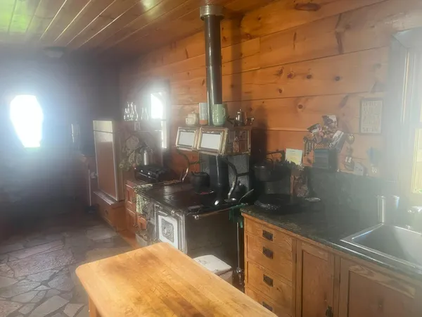a living room with a large window and furniture