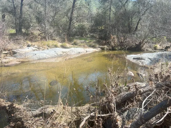 a view of lake with a yard