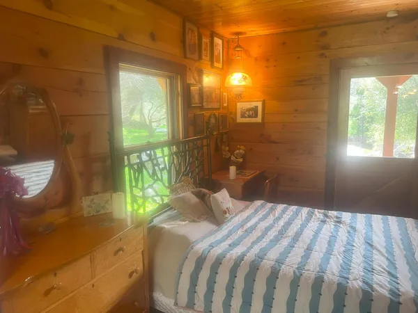 a bedroom with a bed and a window