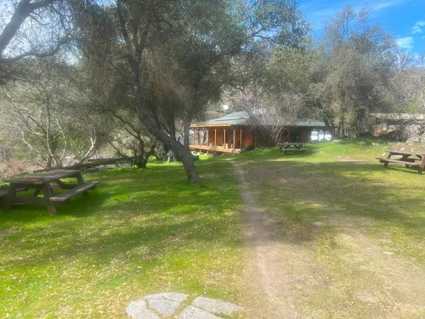 a view of a house with a backyard