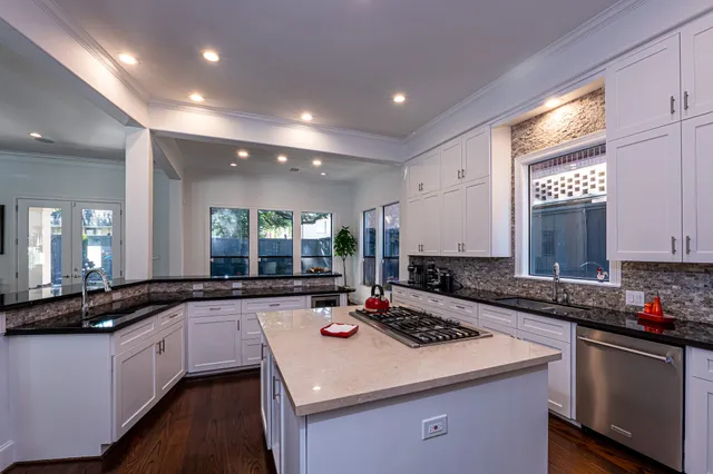 a kitchen with a sink stove and cabinets