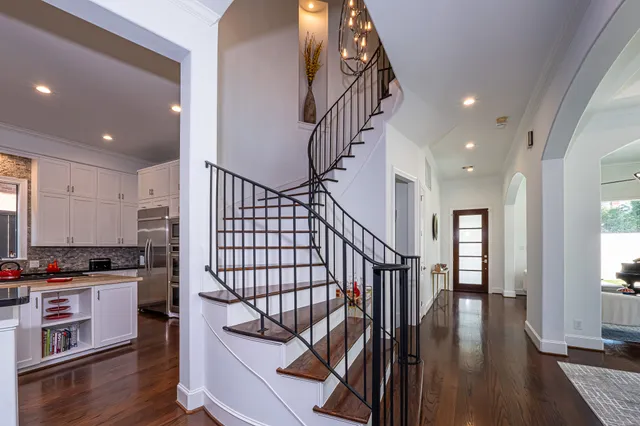 a view of entryway and kitchen with wooden floor