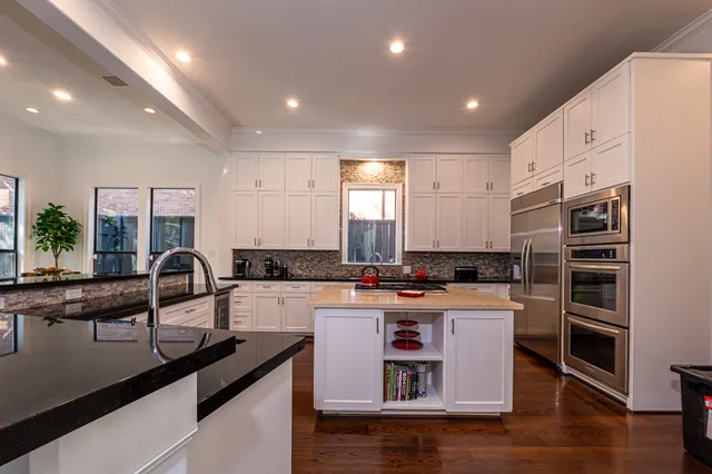 a kitchen with sink a stove and refrigerator