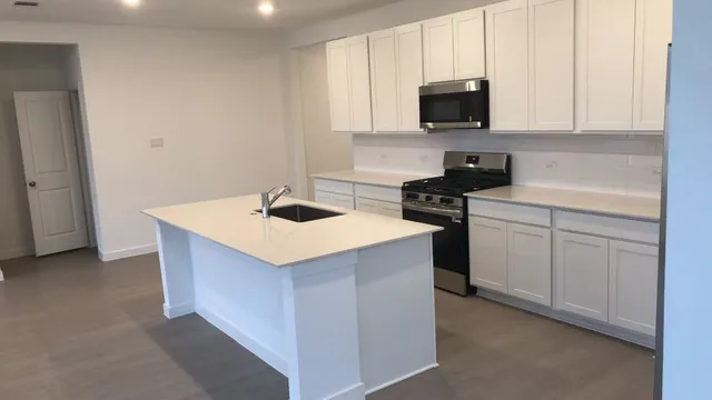 a kitchen that has a sink and a stove in it