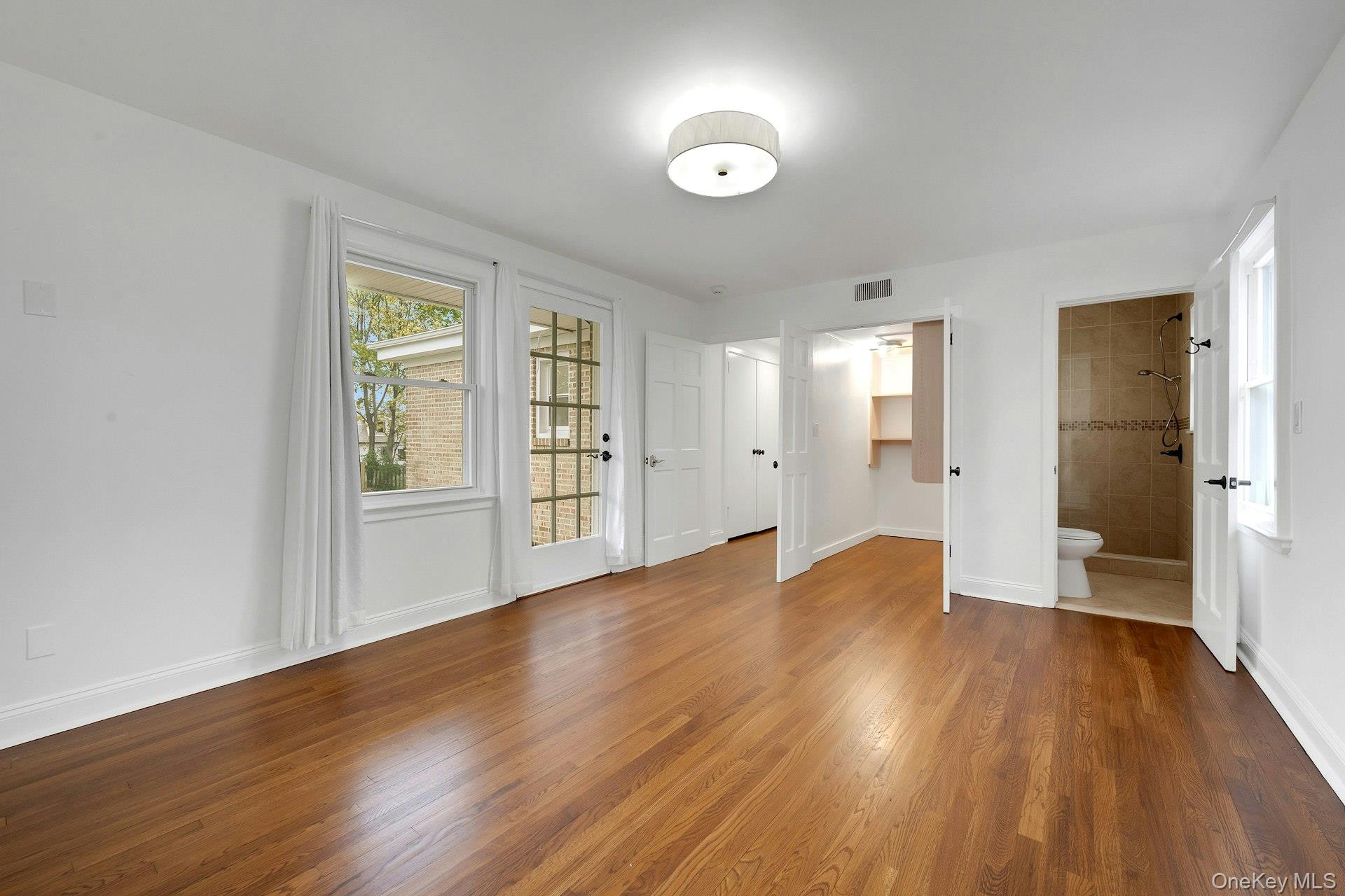 1 Echo Bay Place New Rochelle, NY 10805 - Photo 18 of 47 a view of empty room with wooden floor and fan