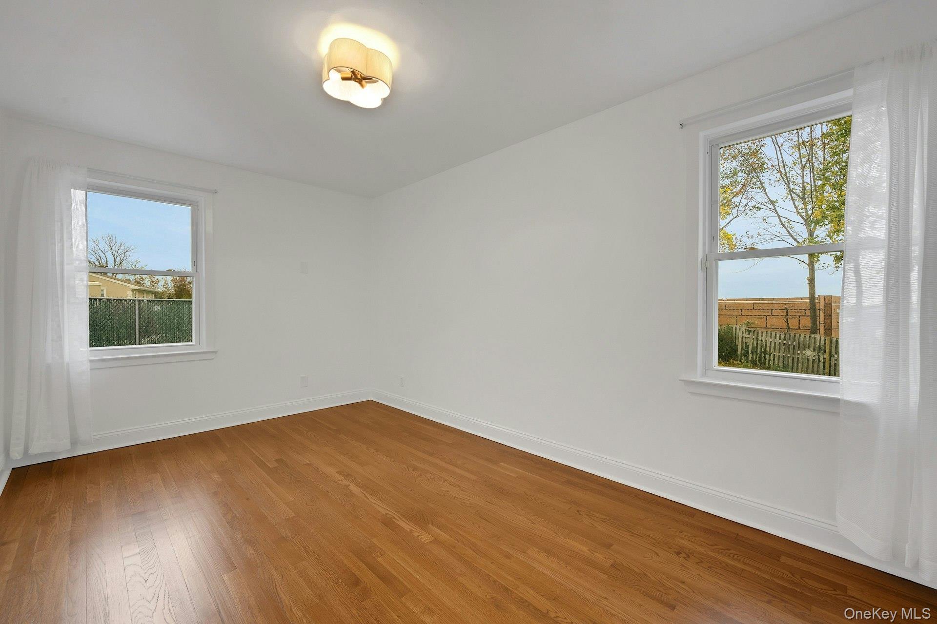 1 Echo Bay Place New Rochelle, NY 10805 - Photo 21 of 47 a view of an empty room with wooden floor and a window