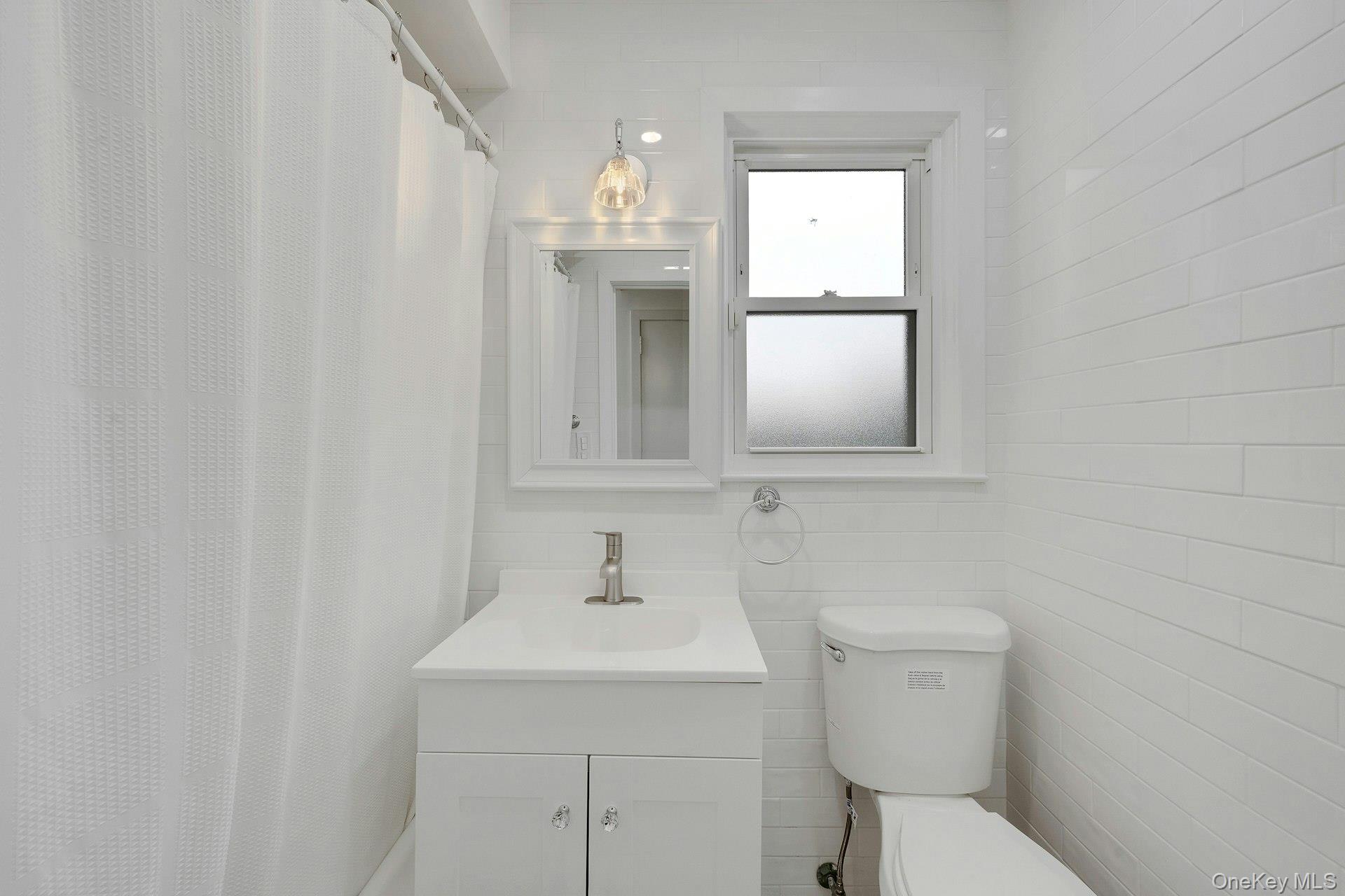1 Echo Bay Place New Rochelle, NY 10805 - Photo 23 of 47 a bathroom with a sink a toilet and mirror