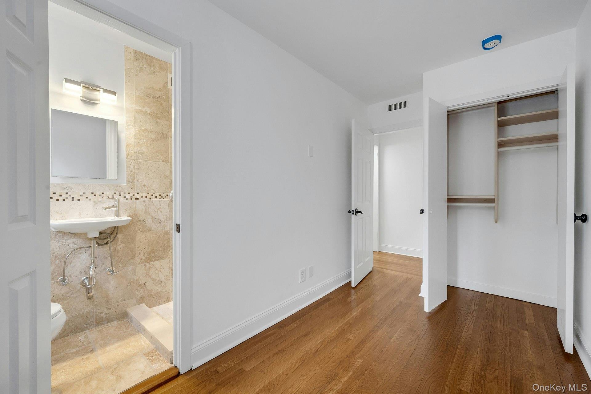 1 Echo Bay Place New Rochelle, NY 10805 - Photo 25 of 47 a view of a hallway with wooden floor