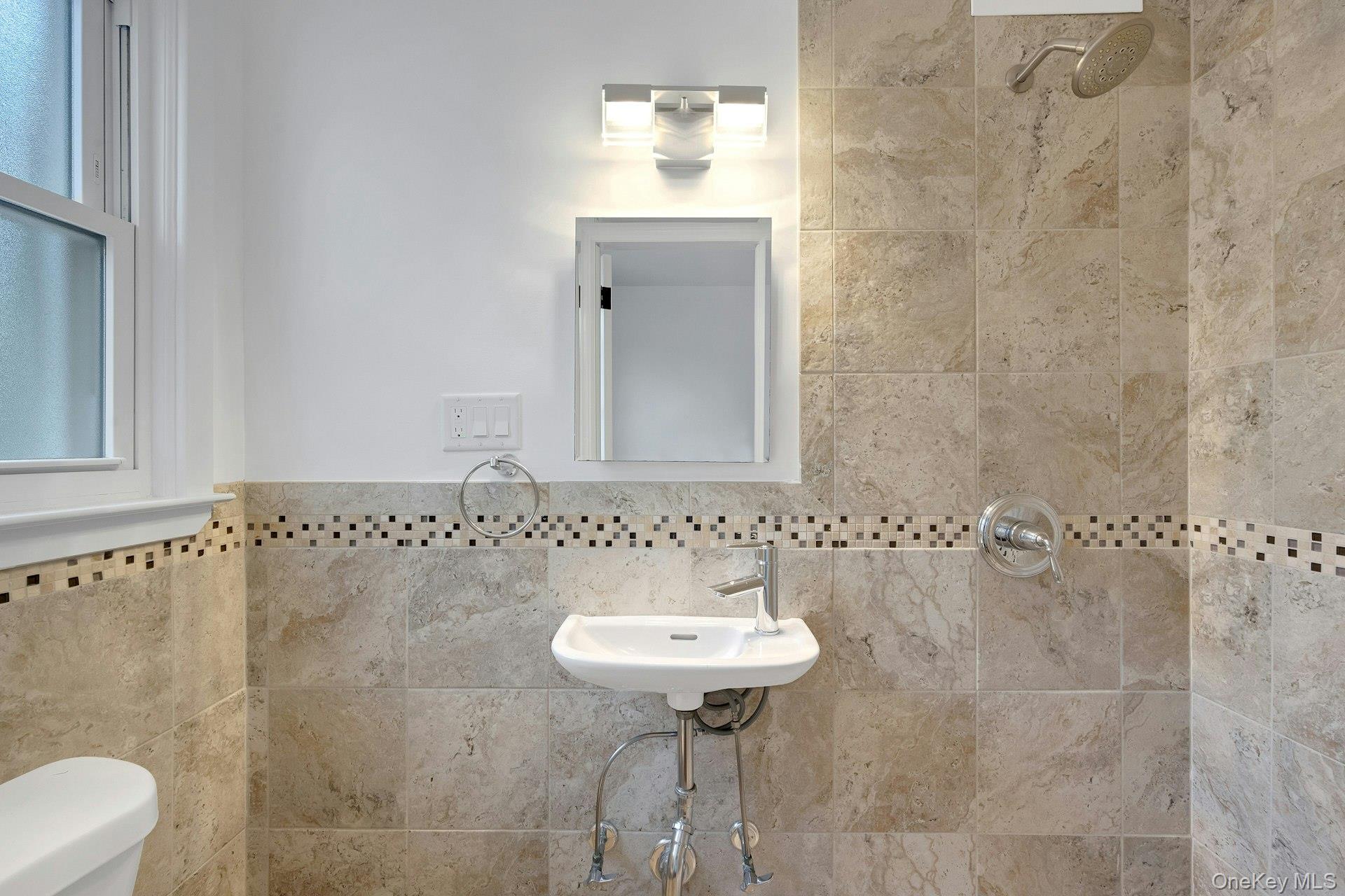 1 Echo Bay Place New Rochelle, NY 10805 - Photo 26 of 47 a bathroom with a sink a toilet and shower