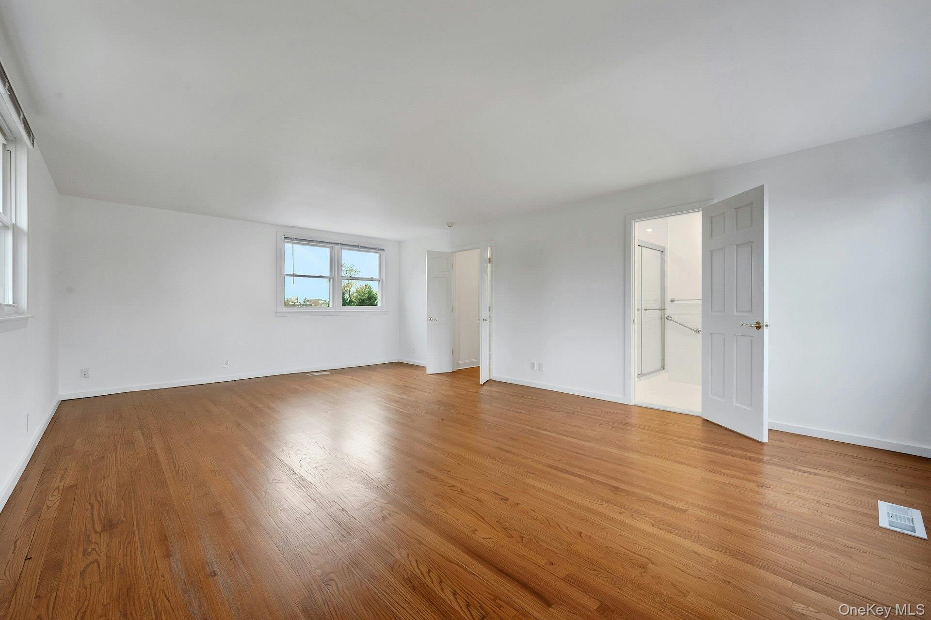 1 Echo Bay Place New Rochelle, NY 10805 - Photo 28 of 47 an empty room with wooden floor and windows