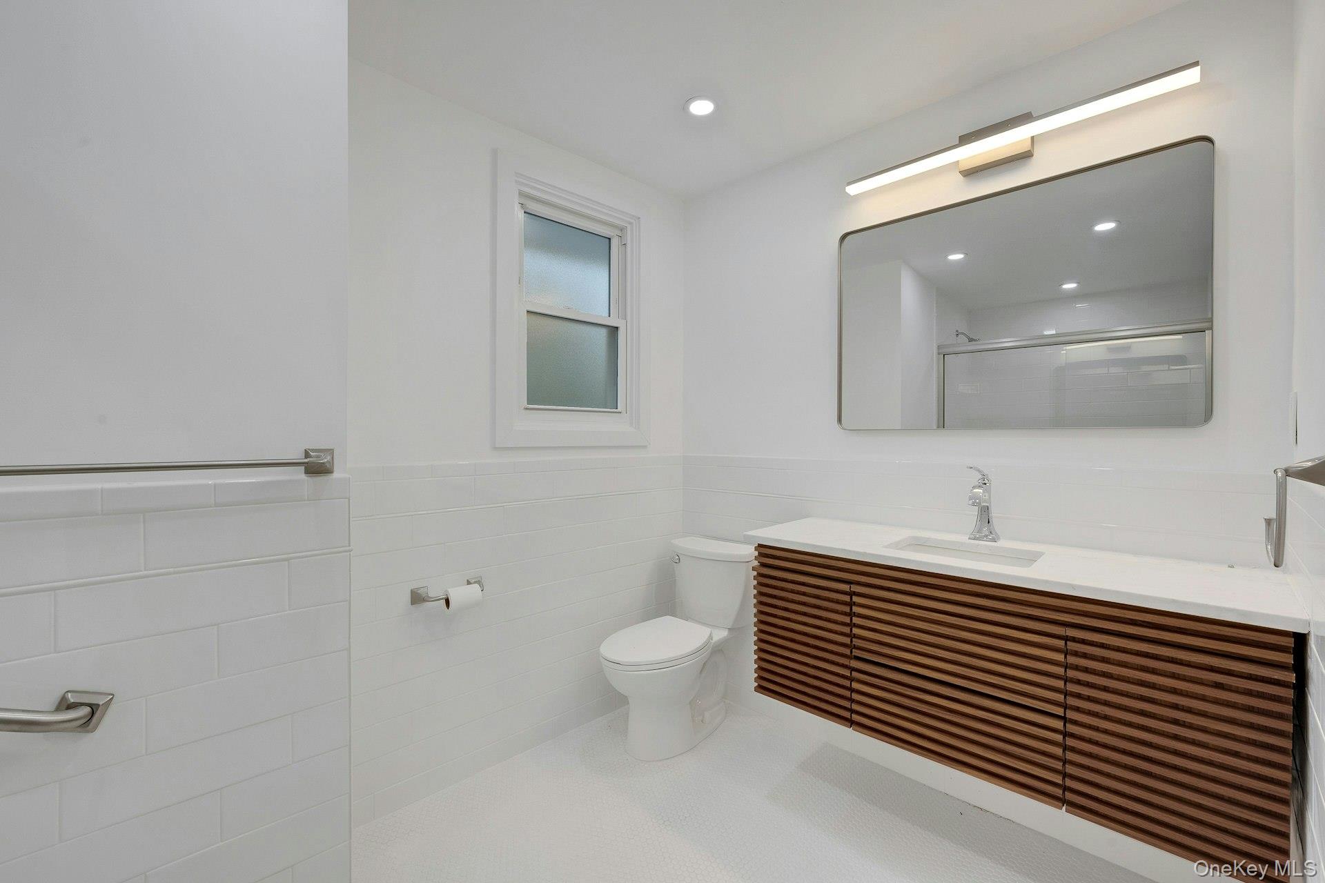 1 Echo Bay Place New Rochelle, NY 10805 - Photo 30 of 47 a bathroom with a sink a toilet and mirror