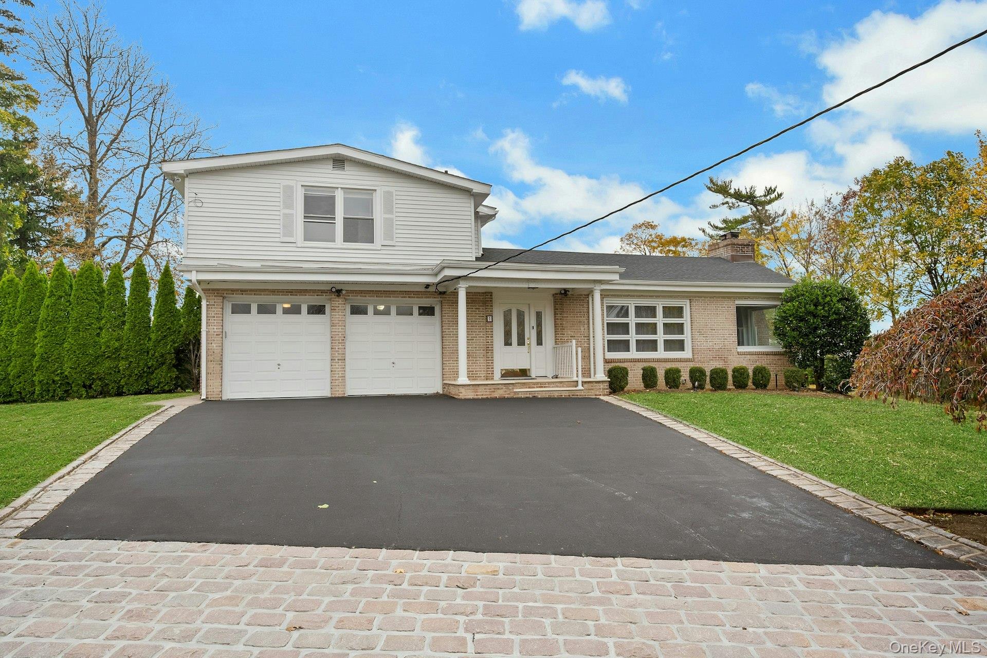 1 Echo Bay Place New Rochelle, NY 10805 - Photo 3 of 47 a front view of a house with a yard and garage