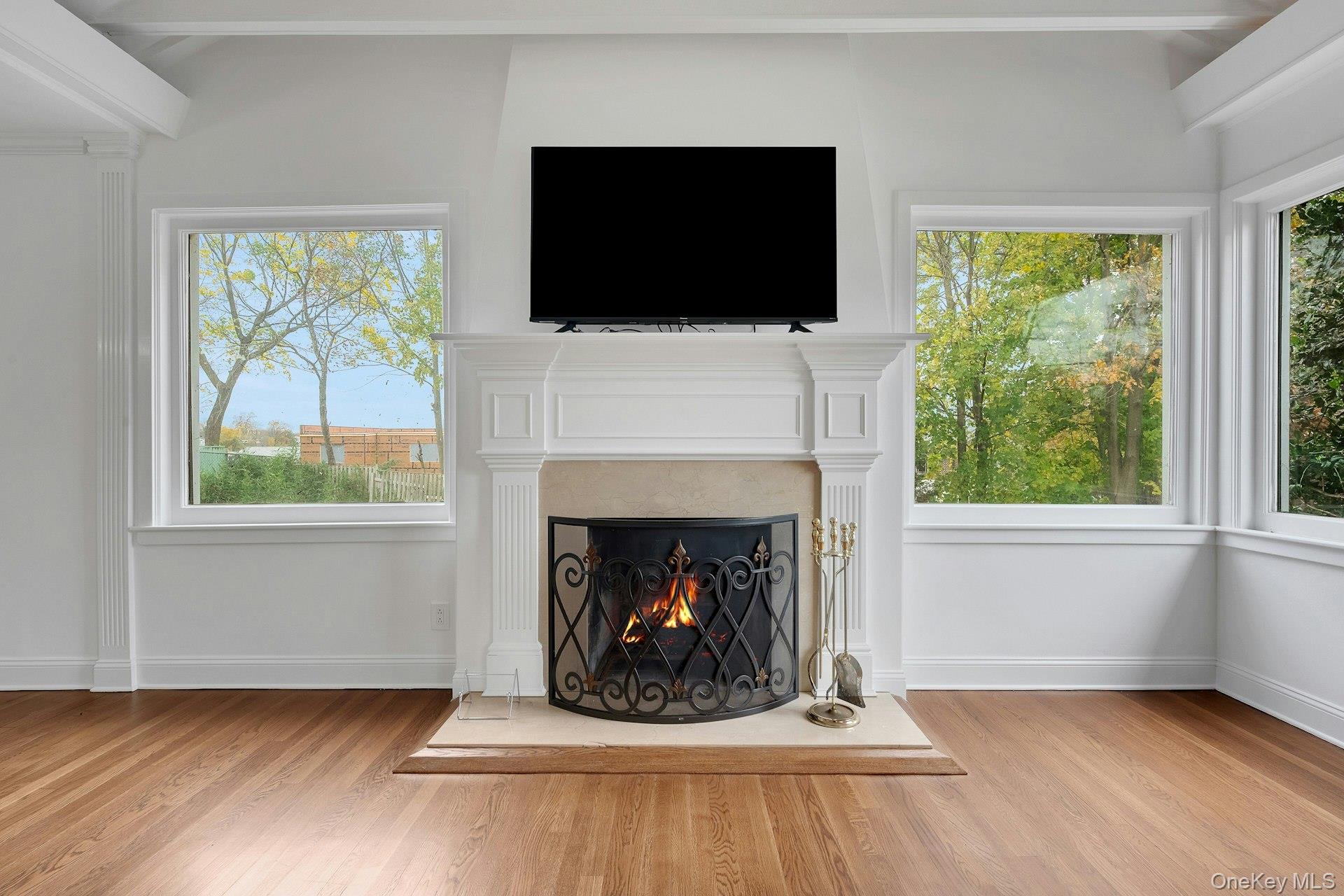 1 Echo Bay Place New Rochelle, NY 10805 - Photo 7 of 47 a living room with a fireplace and a flat screen tv