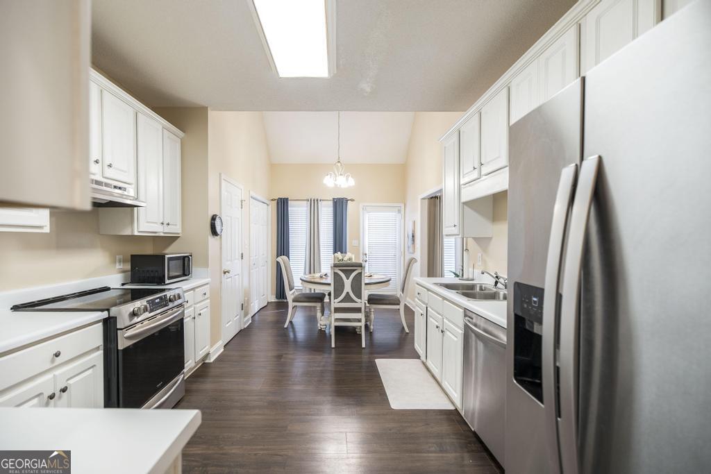 1066 Alma Drive Macon, GA 31216 - Photo 9 of 18 a kitchen with white cabinets and stainless steel appliances