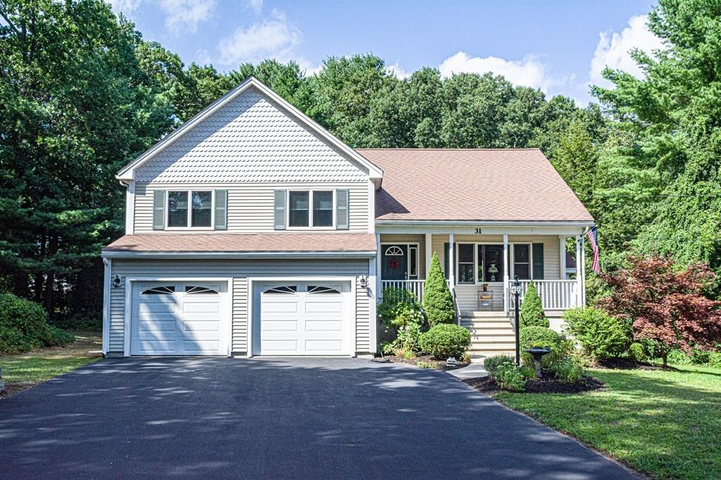 31 Woodland Road Billerica, MA 01821 - Photo 1 of 39 a front view of a house with a garden and plants