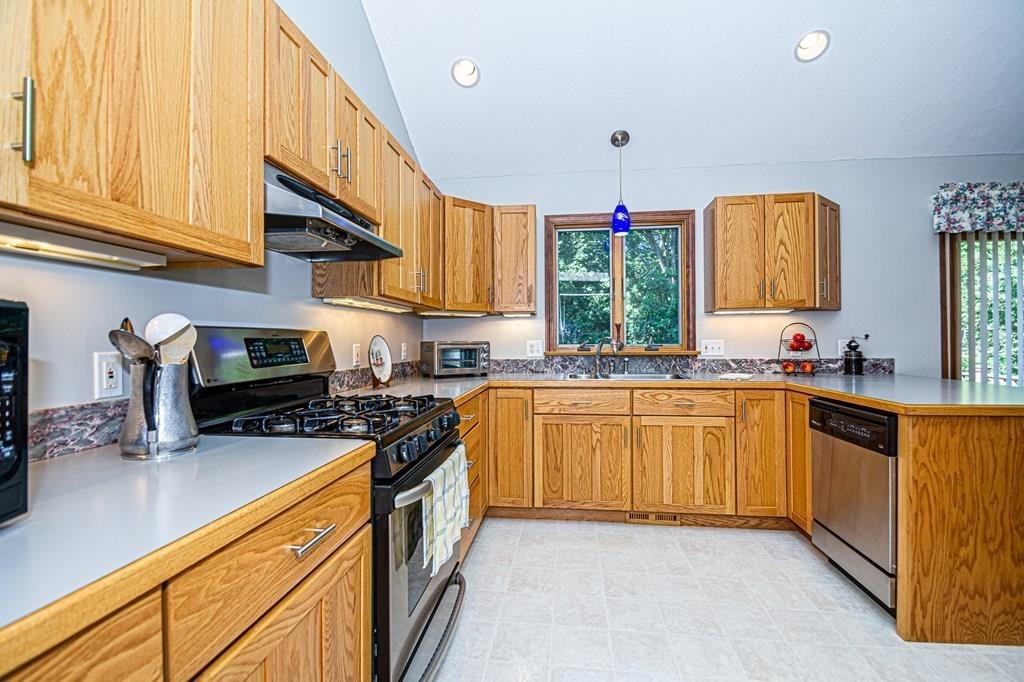 31 Woodland Road Billerica, MA 01821 - Photo 12 of 39 a kitchen with granite countertop a stove sink and cabinets