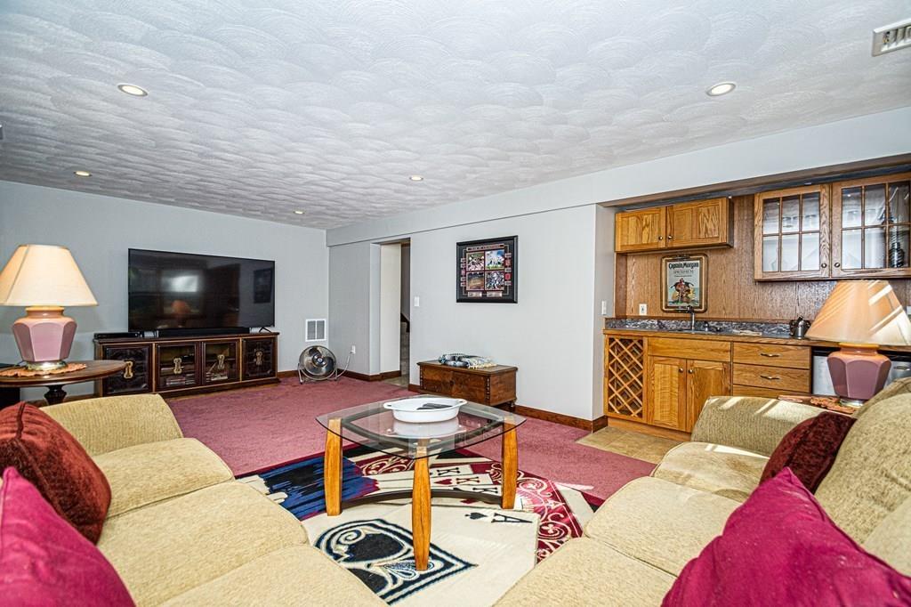 31 Woodland Road Billerica, MA 01821 - Photo 16 of 39 a living room with furniture and a flat screen tv