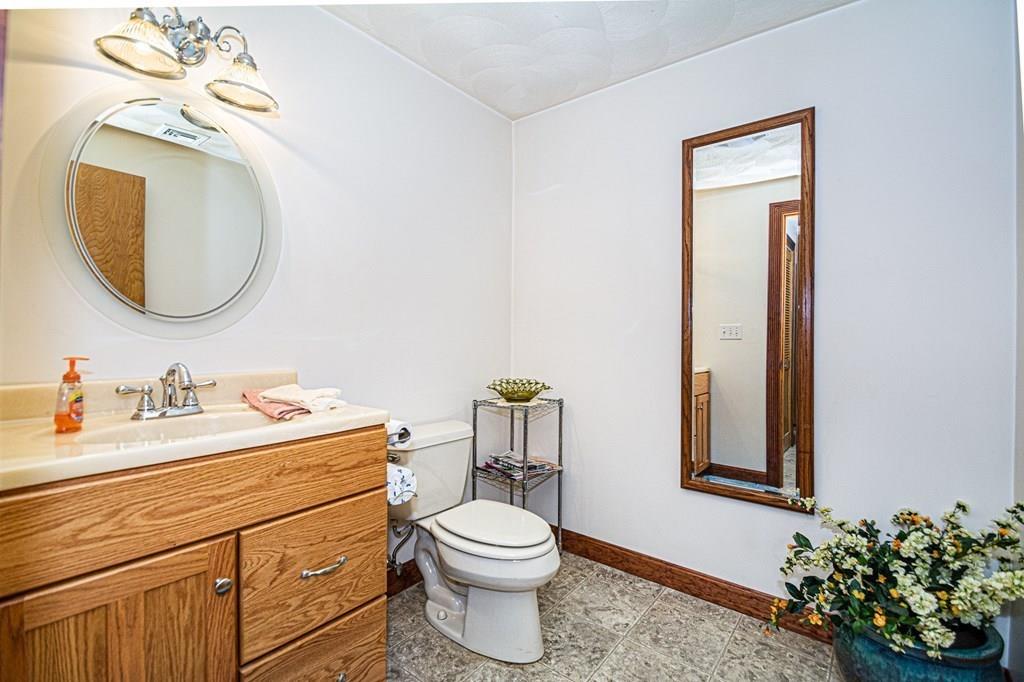 31 Woodland Road Billerica, MA 01821 - Photo 17 of 39 a bathroom with a toilet a sink and mirror
