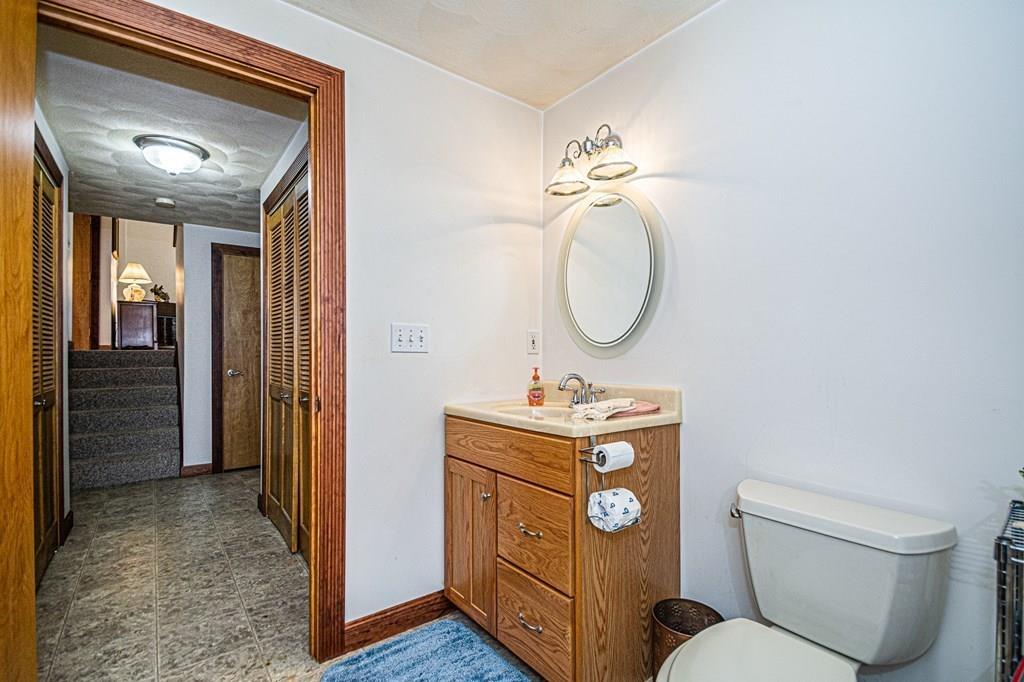 31 Woodland Road Billerica, MA 01821 - Photo 18 of 39 a bathroom with a toilet sink vanity and mirror