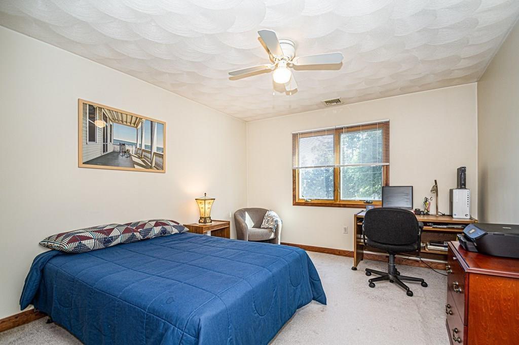 31 Woodland Road Billerica, MA 01821 - Photo 21 of 39 a bedroom with a bed and a chandelier