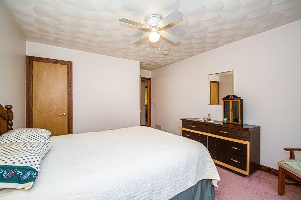 31 Woodland Road Billerica, MA 01821 - Photo 24 of 39 a bedroom with a bed and a chandelier