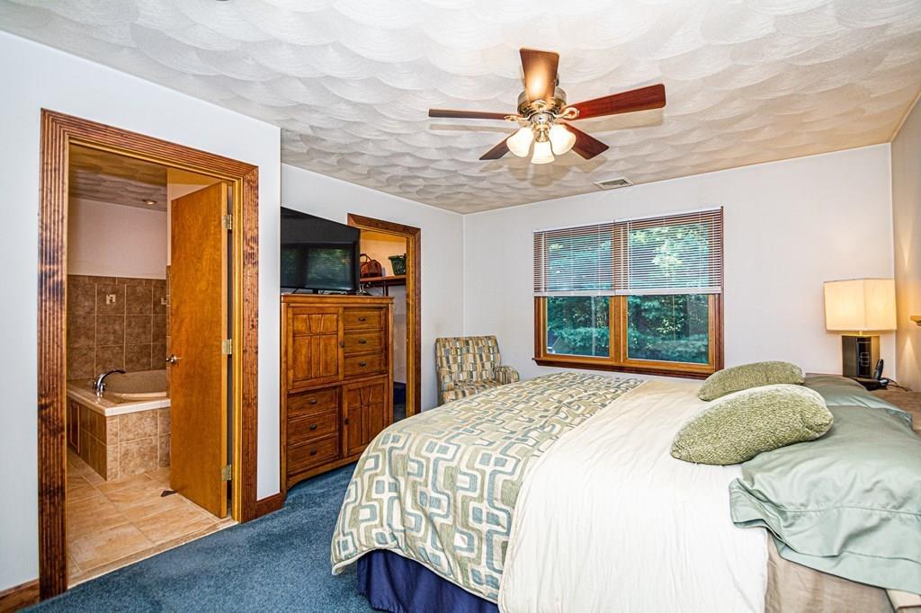 31 Woodland Road Billerica, MA 01821 - Photo 28 of 39 a bedroom with a bed and a large mirror on the dresser