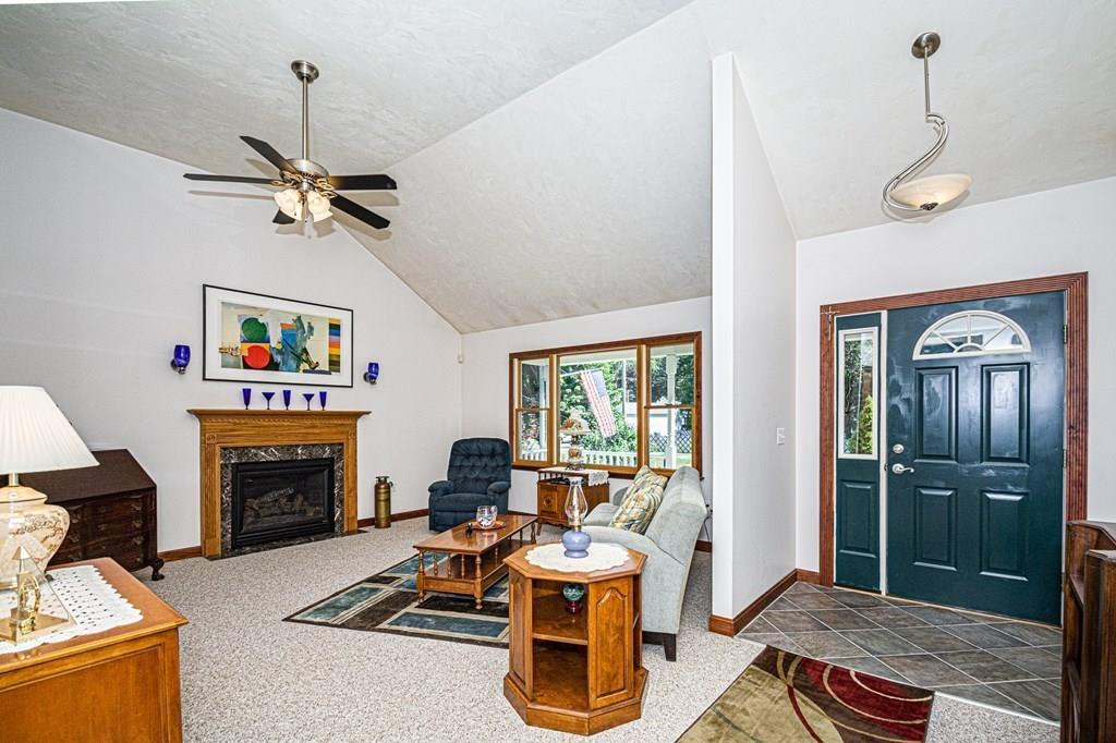 31 Woodland Road Billerica, MA 01821 - Photo 3 of 39 a living room with furniture a chandelier and a fireplace