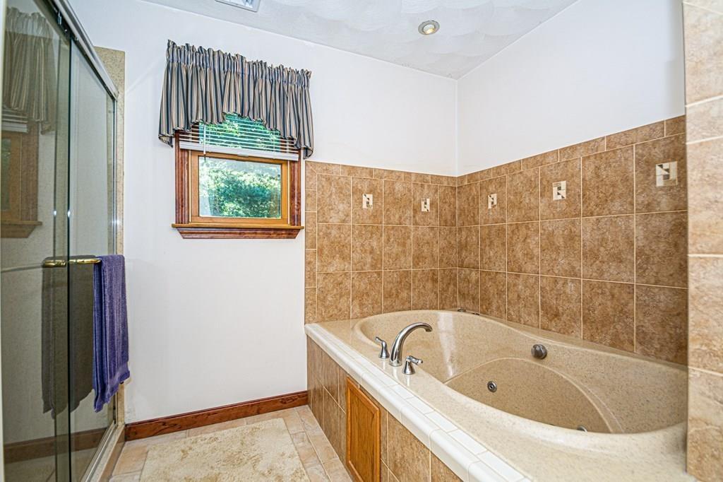 31 Woodland Road Billerica, MA 01821 - Photo 32 of 39 a bathroom with a bathtub and shower