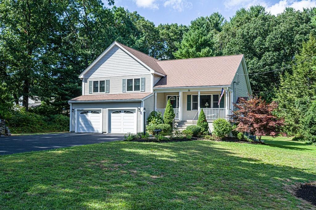 31 Woodland Road Billerica, MA 01821 - Photo 35 of 39 a front view of a house with a garden and yard