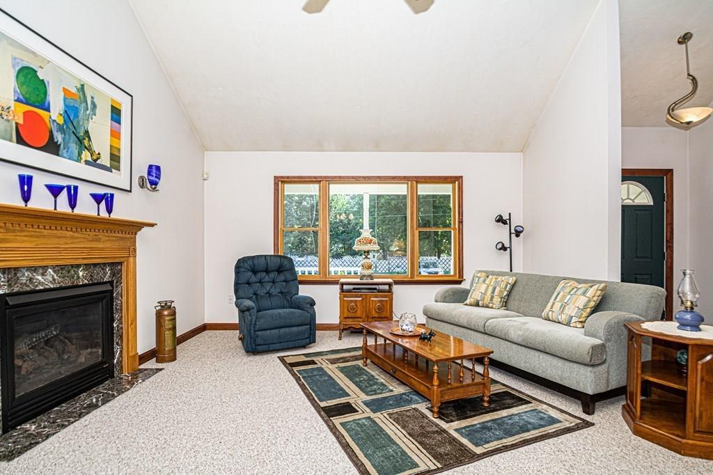 31 Woodland Road Billerica, MA 01821 - Photo 5 of 39 a living room with furniture a fireplace and a large window