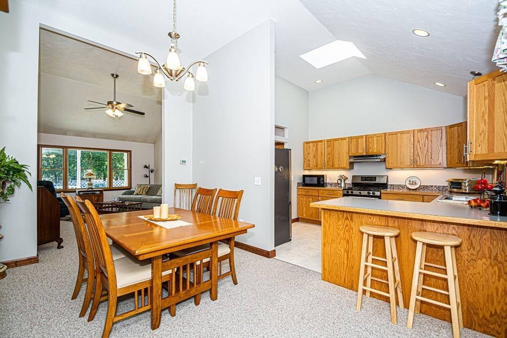 31 Woodland Road Billerica, MA 01821 - Photo 9 of 39 a dining room with furniture a chandelier and kitchen view