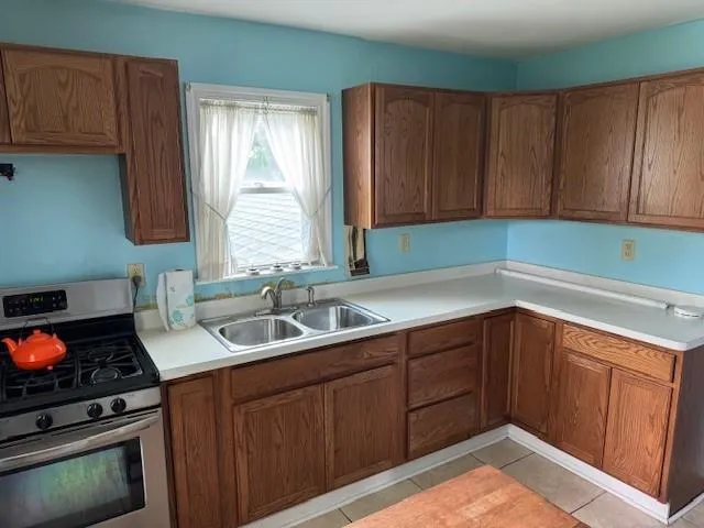 a kitchen with a sink cabinets and window
