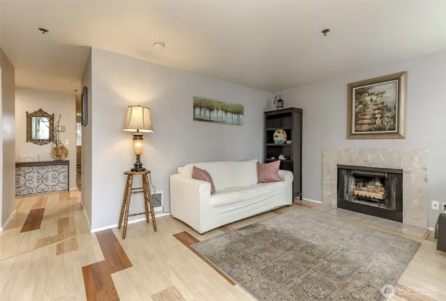 a living room with furniture and a fireplace