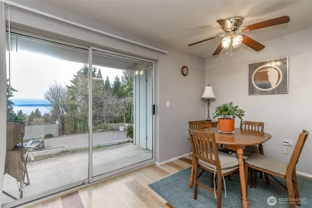 a dining room with furniture and a floor to ceiling window