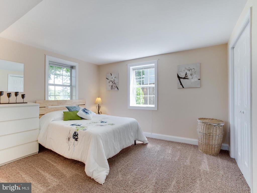 132 Oakwood Road Edgewater, MD 21037 - Photo 26 of 37 a bed sitting in a bedroom next to a window