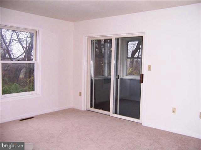 624 Colonial View Road Mechanicsburg, PA 17055 - Photo 4 of 8 an empty room with windows